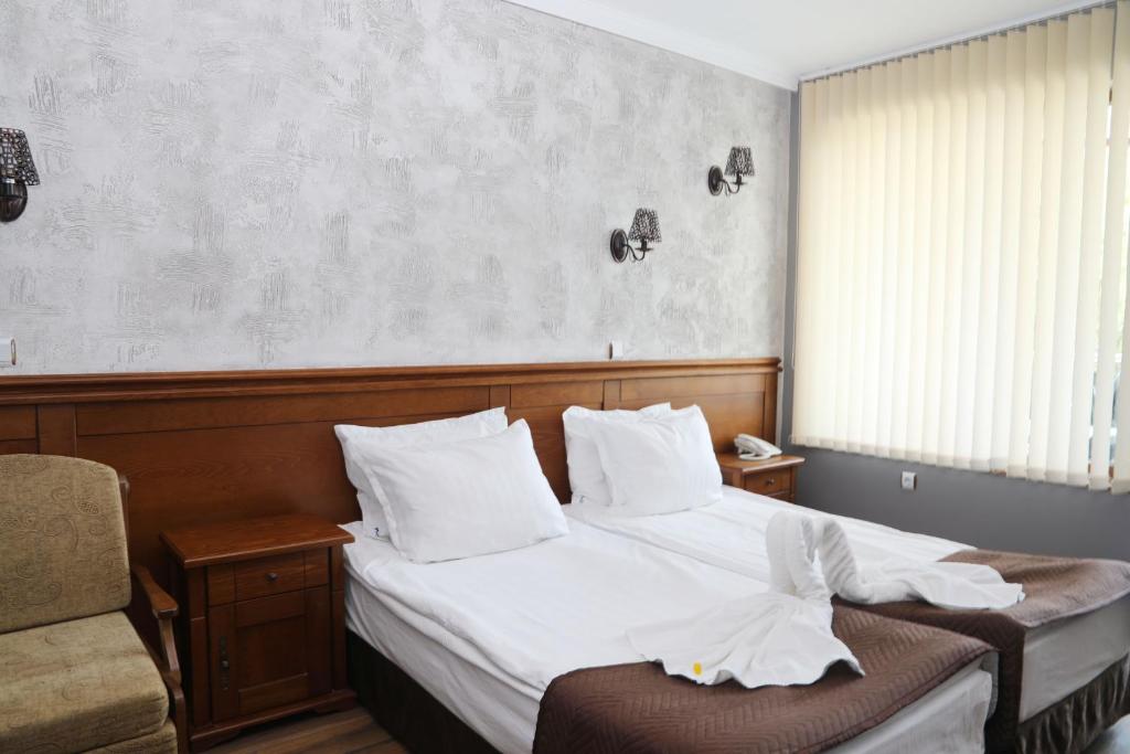 Postel nebo postele na pokoji v ubytování Petrov Family Hotel