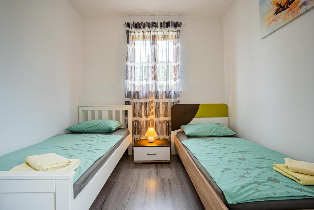 Postel nebo postele na pokoji v ubytování Apartment Livia