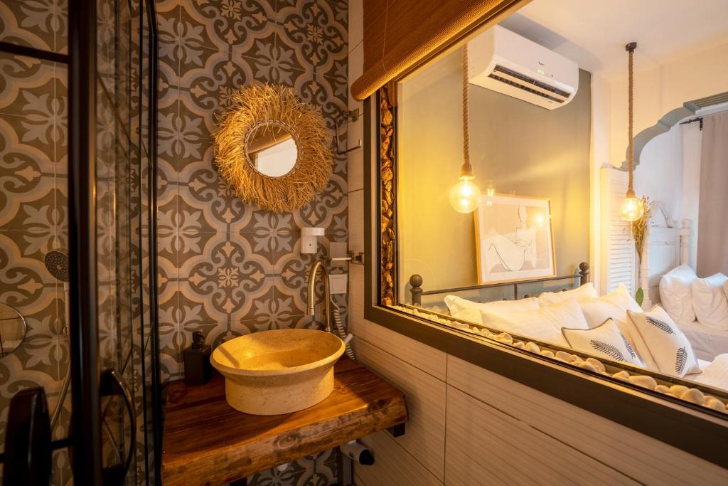 a bathroom with a sink and a mirror at Liman Hotel Gümüslük - Adult Only in Bodrum City