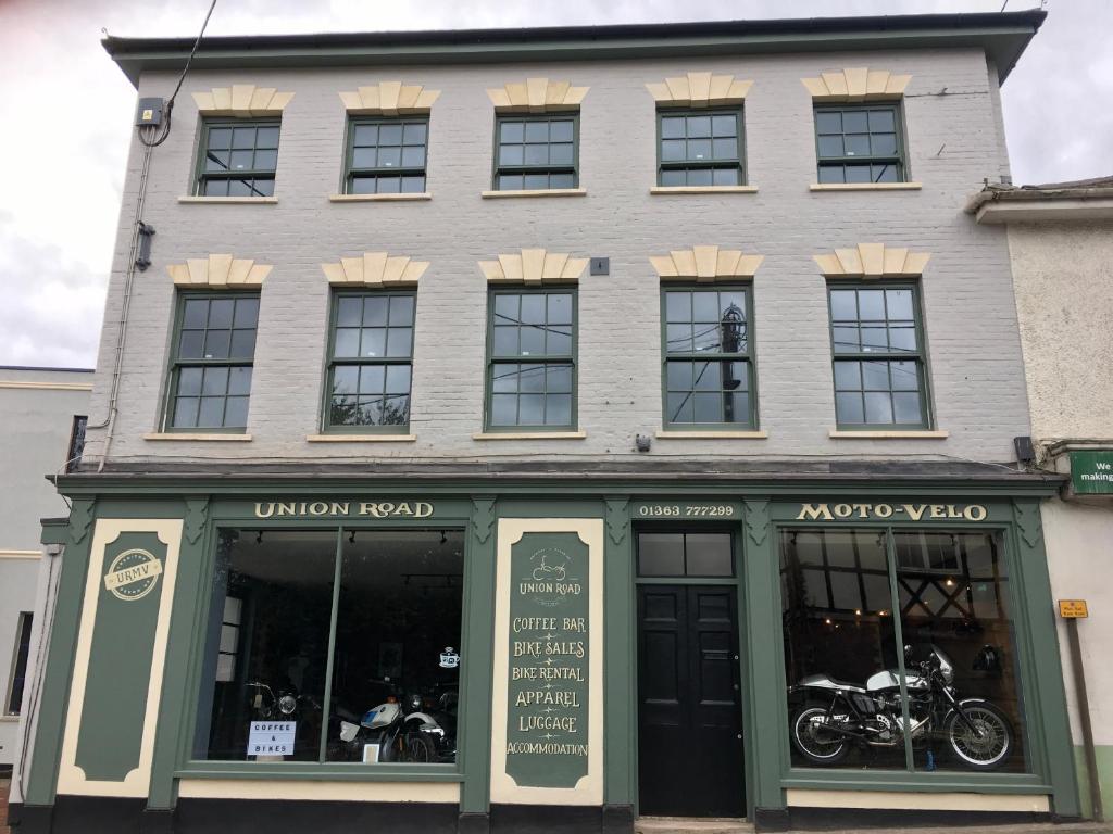 a building with motorcycles parked in front of it at Union Road Moto Velo Accommodation in Crediton