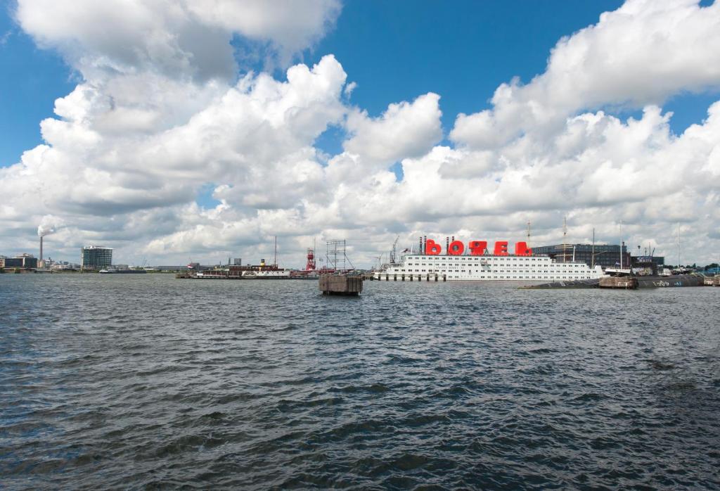 a large cruise ship is docked in the water at Botel in Amsterdam
