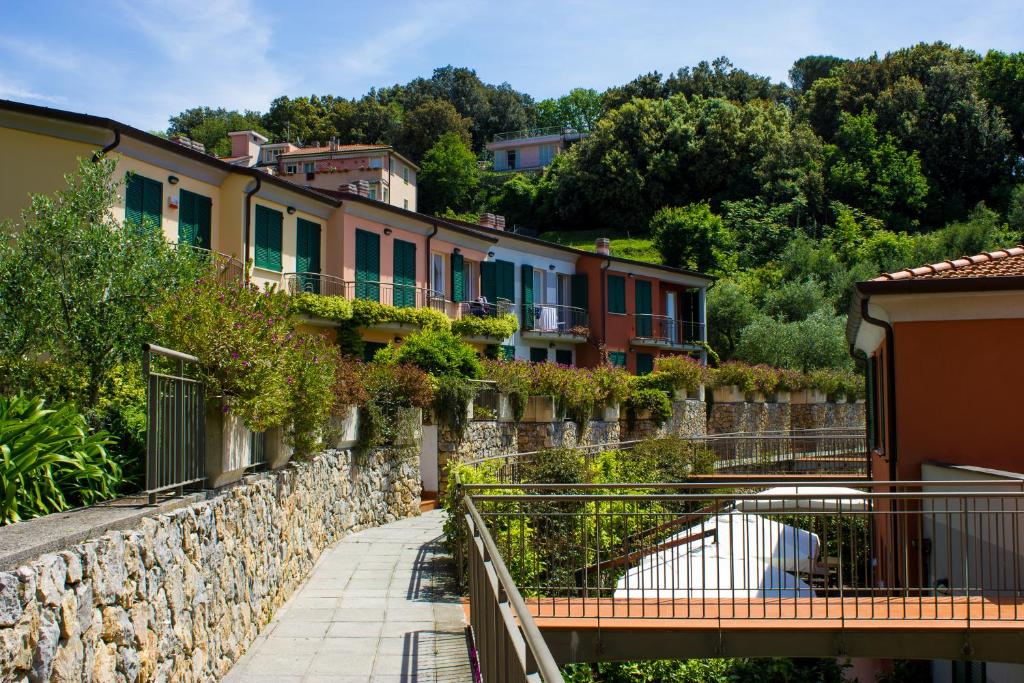 a group of houses on a hill with a bridge at Baia Blu RTA Residence in Lerici