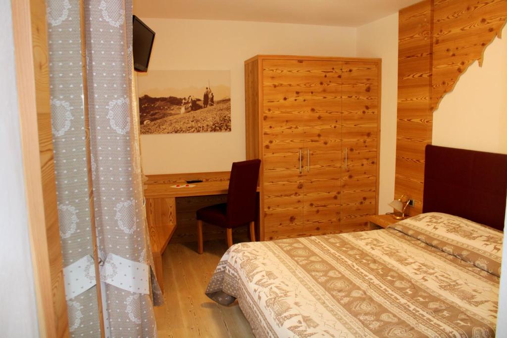 Postel nebo postele na pokoji v ubytování Hotel Villa Cima Undici