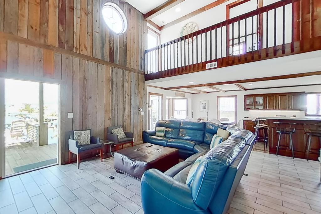 a living room with a couch and a table at Miramar in Holden Beach