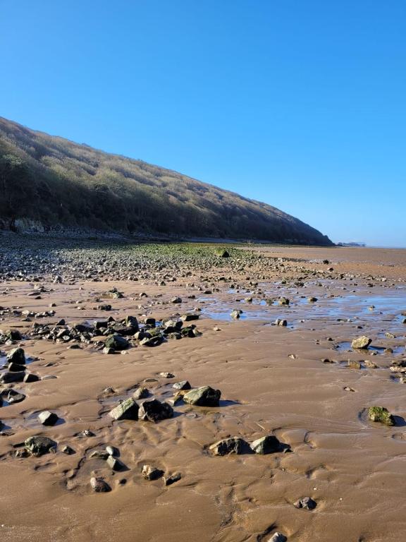 a sandy beach with rocks in the sand at South Sands Hotel in Weston-super-Mare