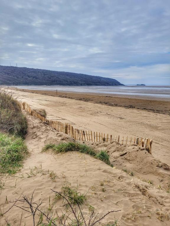 a sandy beach with a fence in the sand at South Sands Hotel in Weston-super-Mare