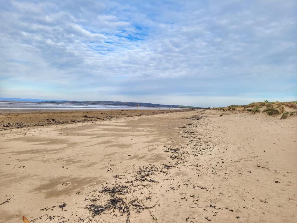 an empty beach with footprints in the sand at South Sands Hotel in Weston-super-Mare