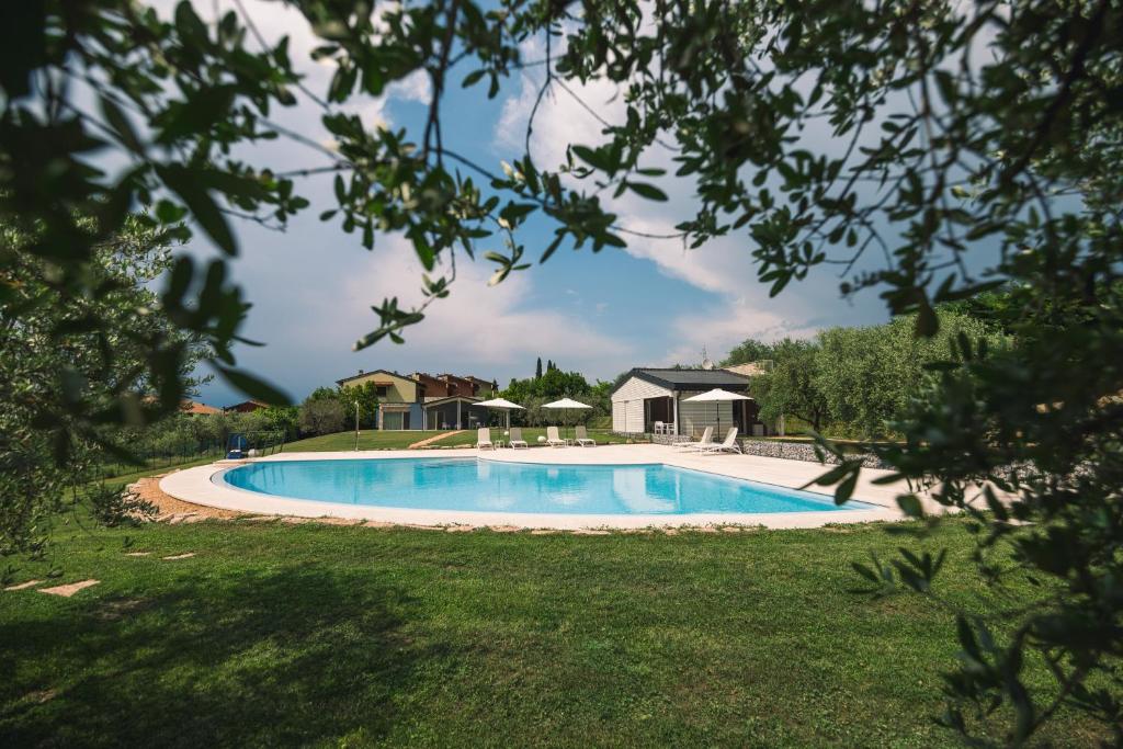 a swimming pool in the yard of a house at Relais del Garda in Lazise