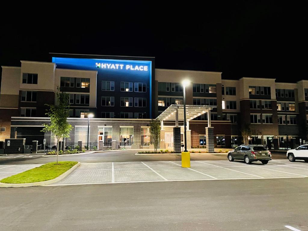a parking lot in front of a hotel at night at Hyatt Place Murfreesboro in Murfreesboro