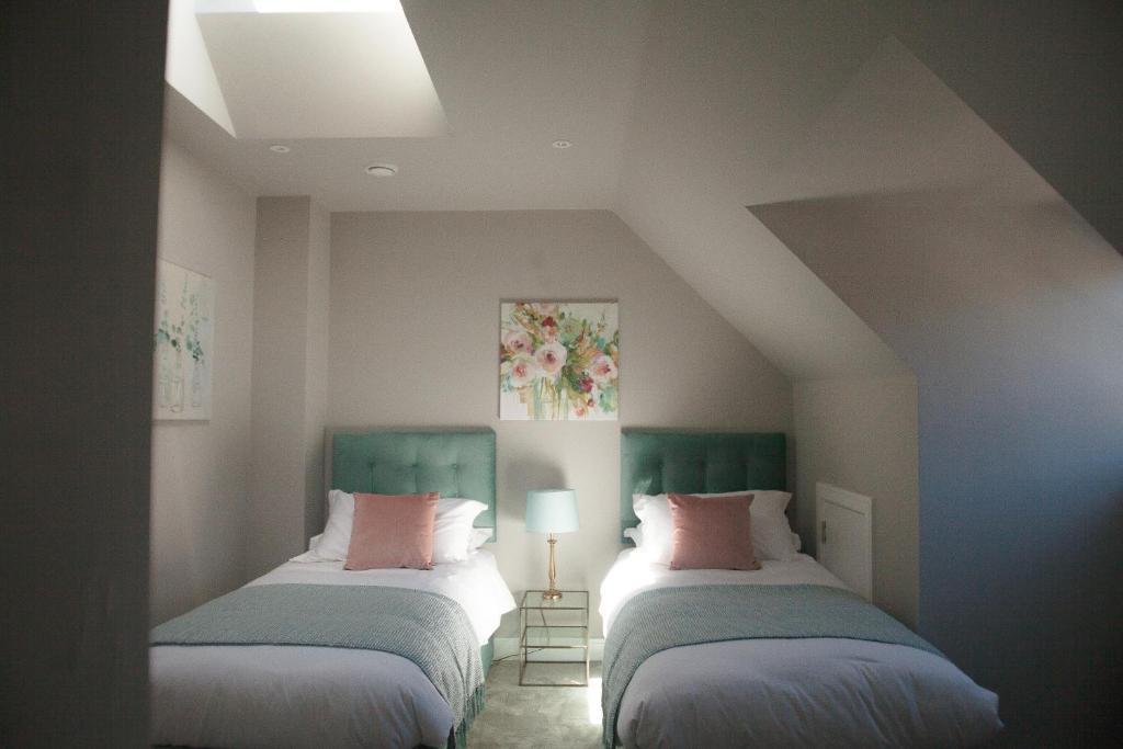 a room with two beds in a room at The Loft, Bootham House - luxury city centre apartment with parking space in York