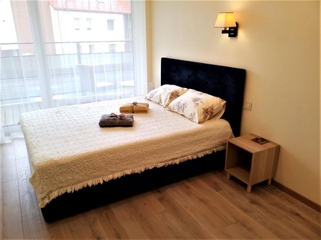 a bedroom with a bed with two bags on it at Beautiful Apartment in the heart of Birstonas in Birštonas