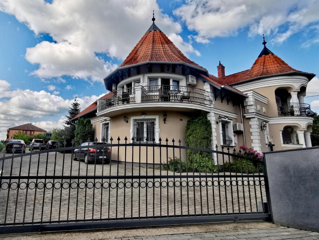 ein altes Haus mit einem Zaun davor in der Unterkunft Admirál Villa Felnőttbarát szálláshely in Kehidakustány