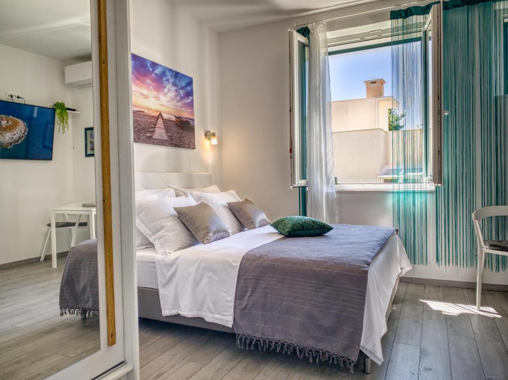 Postel nebo postele na pokoji v ubytování SmartMini Apartments