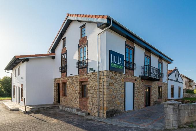 a building with a sign on the side of it at LLULLA.ES in Cortiguera