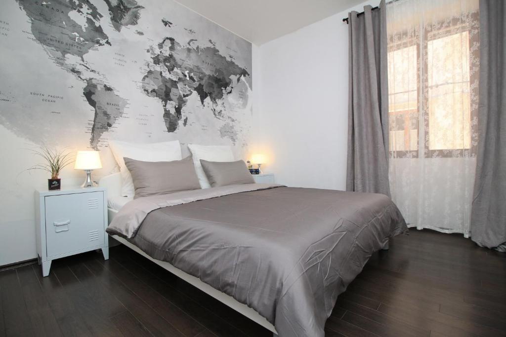 a bedroom with a bed with a map on the wall at Carrera Corner Apartment in Rovinj