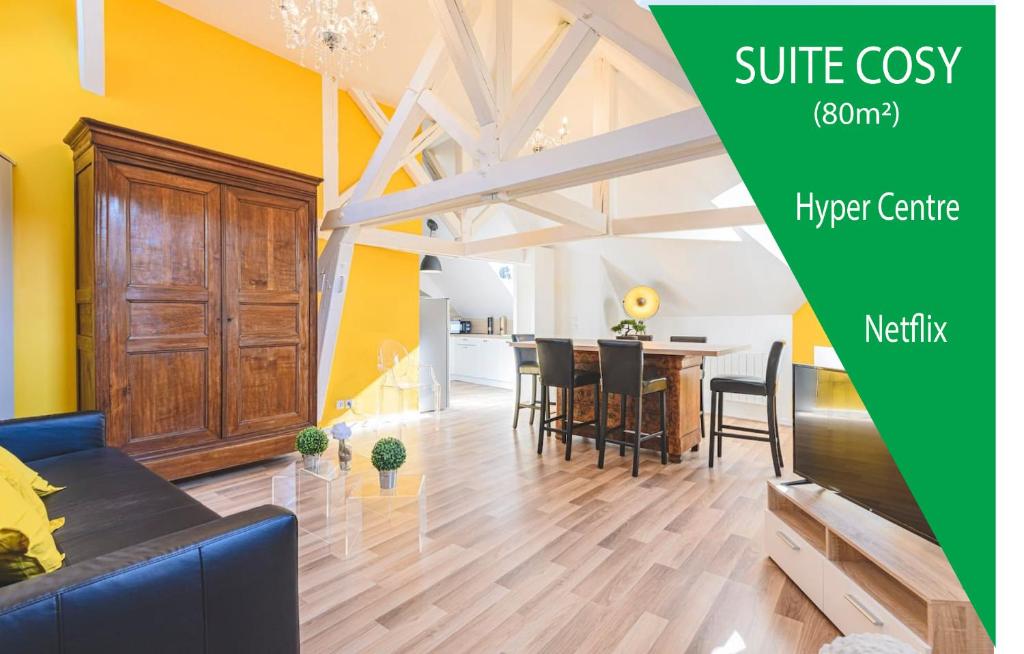 a living room with a couch and a dining room at Suite PREMIUM LE FIGARO 2 in Épernay