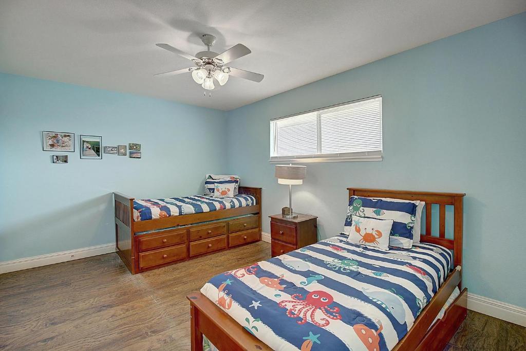 a bedroom with two beds and a ceiling fan at Under The Sea 405BH in Port Aransas