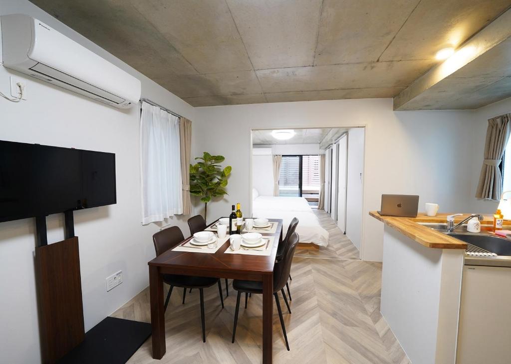 a kitchen and dining room with a table and chairs at Laffitte Tokyo WEST in Tokyo