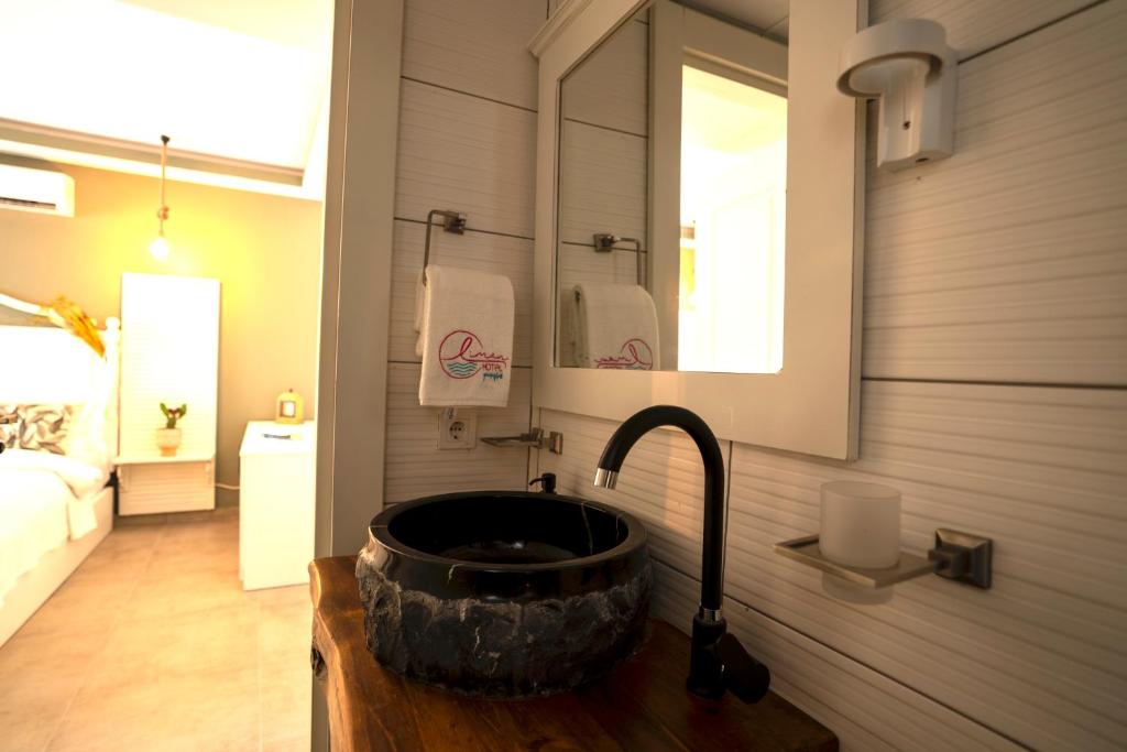 a bathroom with a sink and a mirror at Liman Hotel Gümüslük - Adult Only in Bodrum City