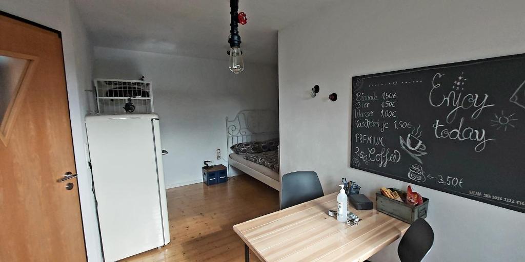 Habitación con mesa y pizarra en la pared en Apart of "MET" en Mellrichstadt