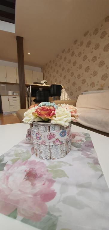 a room with a table with flowers on it at ApartmanyStocklova2 in Bardejov
