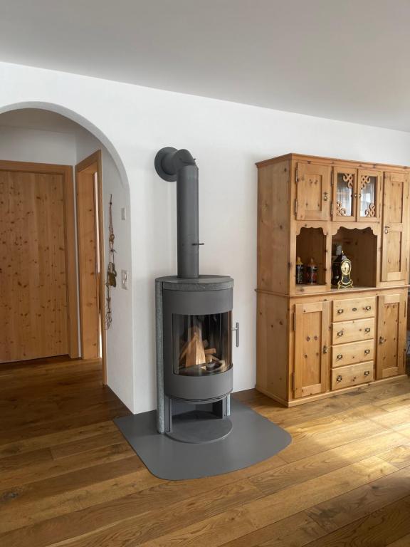 a living room with a stove in the corner at Ferienwohnung mit idyllischer Aussicht in Klosters