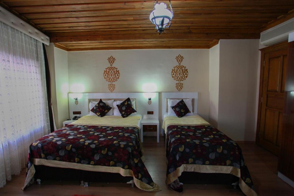 Postel nebo postele na pokoji v ubytování Bacchus Pension