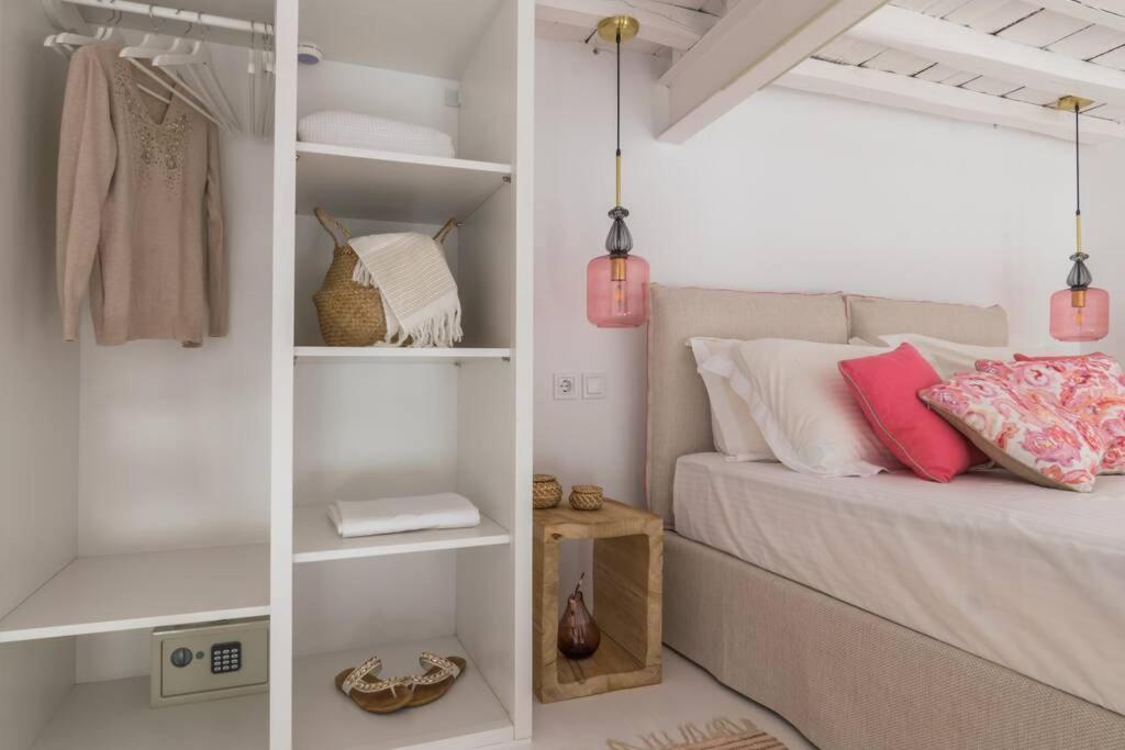 a bedroom with a bed and white shelves at Stella's House in Kimolos