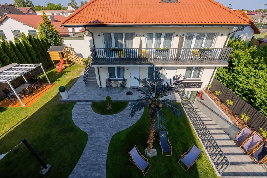 an aerial view of a house with a palm tree at Amber Tiger Villa in Pobierowo