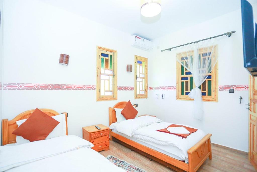 Postel nebo postele na pokoji v ubytování Maison d'hôtes Tinwitchi