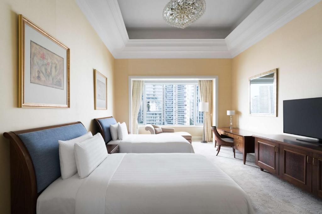 Postel nebo postele na pokoji v ubytování Shangri-La Singapore
