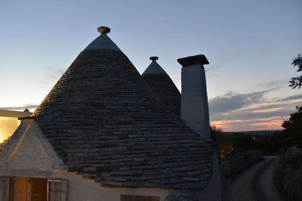 a roof of a house with three chimneys on it at Dimore Barsento in Alberobello