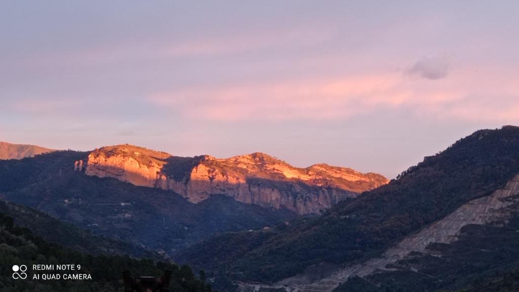 a mountain range with the sun setting on it at Agriturismo Vecchio Frantoio in Villatella