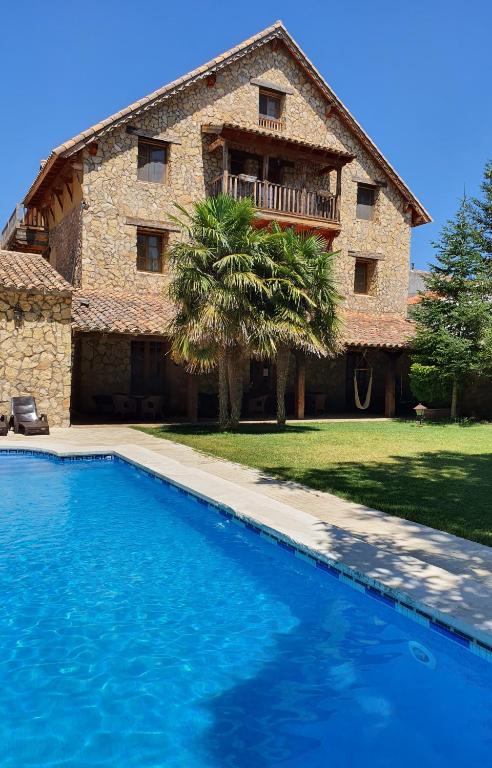 a house with a swimming pool in front of it at Tierras de Moya in Los Huertos
