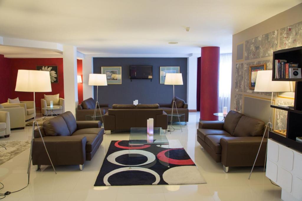 a living room with couches and a rug at Chateau La Roca in Sancibrián