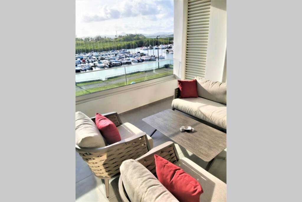 a living room with a view of a harbor at Appartement neuf vue Marina étang Z'abricot FDF in Fort-de-France