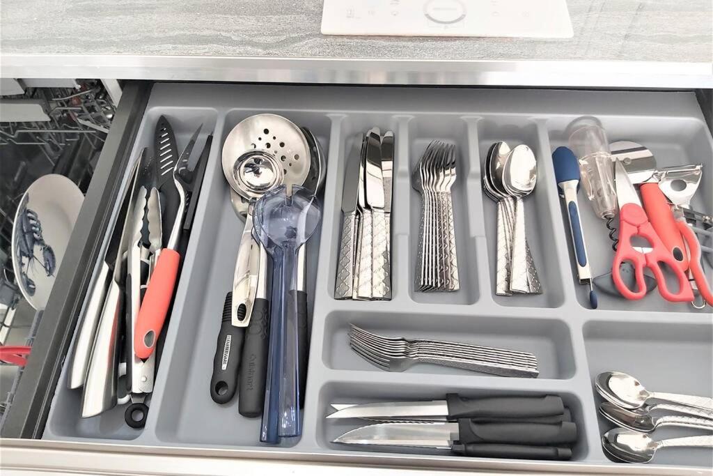 a tray filled with utensils in a drawer at Appartement neuf vue Marina étang Z&#39;abricot FDF in Fort-de-France