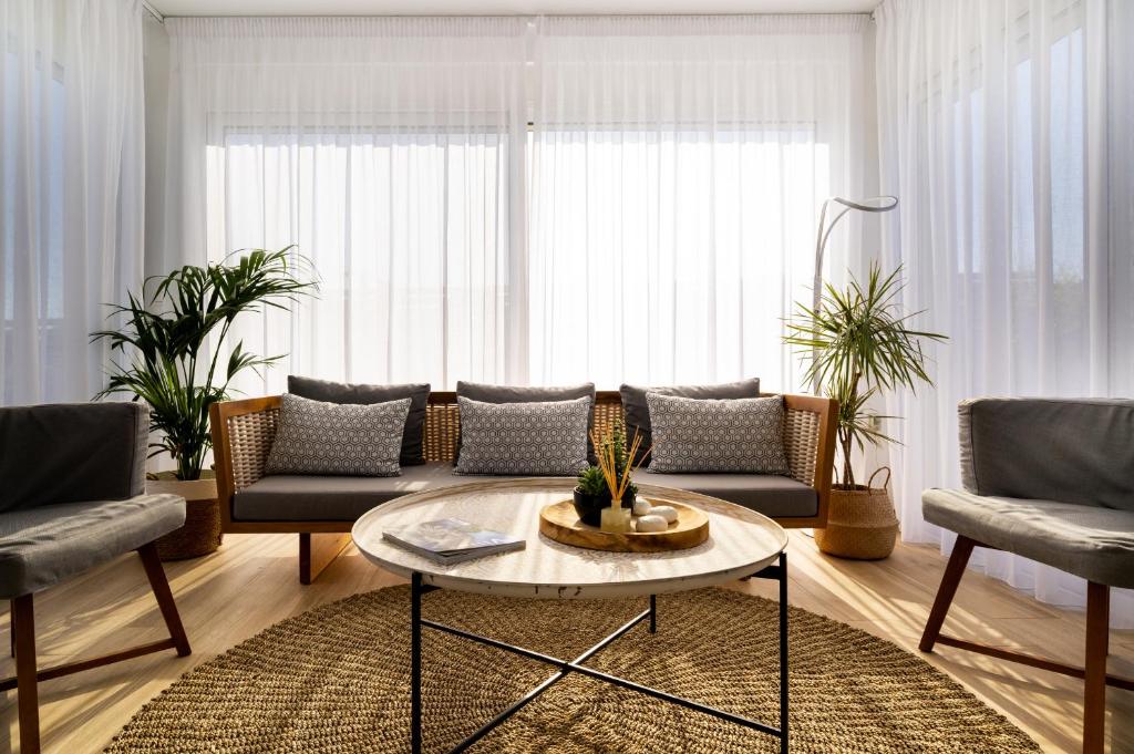 a living room with a couch and a table at Sardines Luxury Villas in Analipsi