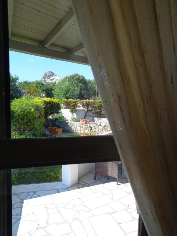 a view of a garden from a window at To Pithari in Skiros