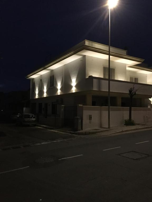 un bâtiment avec un éclairage de rue devant lui la nuit dans l'établissement Tom & Ros House, à Casarano