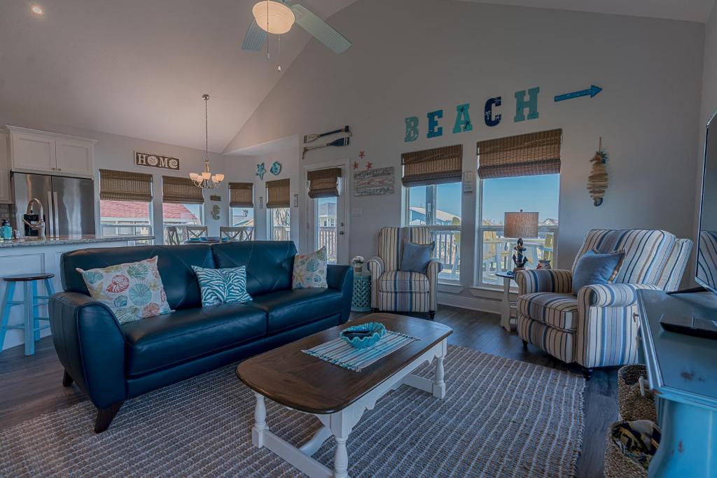 a living room with a couch and a table at The Coast is Clear Amazing home in Sea Isle Short distance to the Beach in Galveston