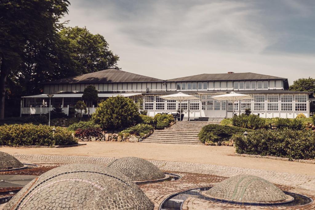 a building with stairs and umbrellas in front of it at Arnbjerg Pavillonen in Varde