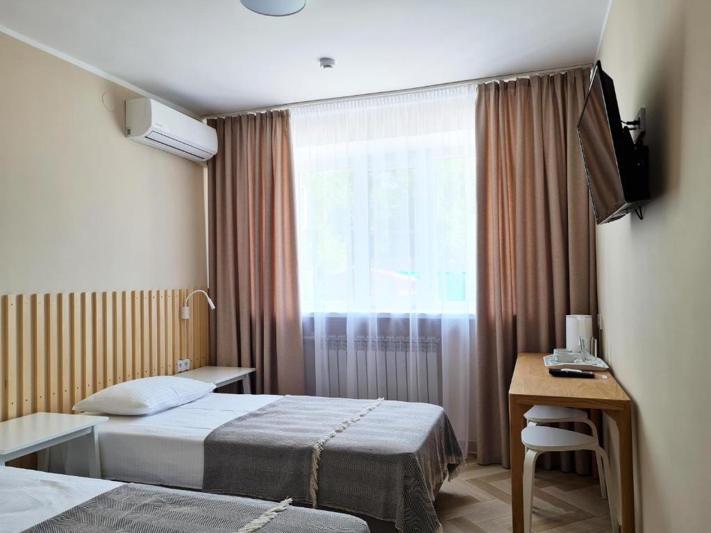 a hotel room with two beds and a window at Hotel Don in Pavlovsk