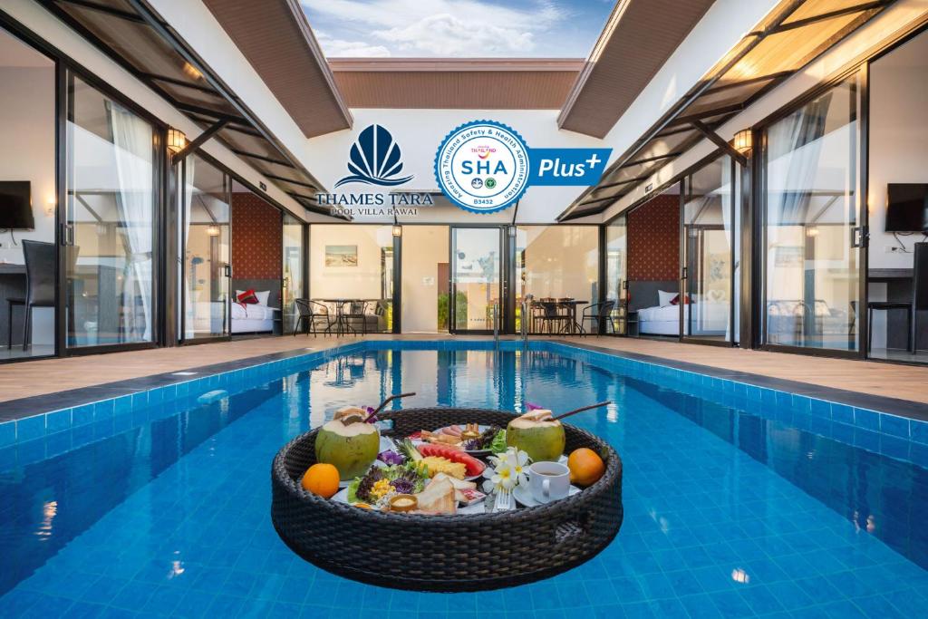 a pool with a bowl of food in a swimming pool at Thames Tara Pool Villa Rawai Phuket - SHA Extra Plus in Rawai Beach