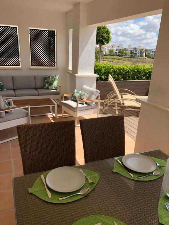 a table and chairs with plates on top of it at Casa El Tonelero, Casa Del Pequeno Tonelero & Casa Del Gran Tonelero - by El Tonelero Ltd in Sucina