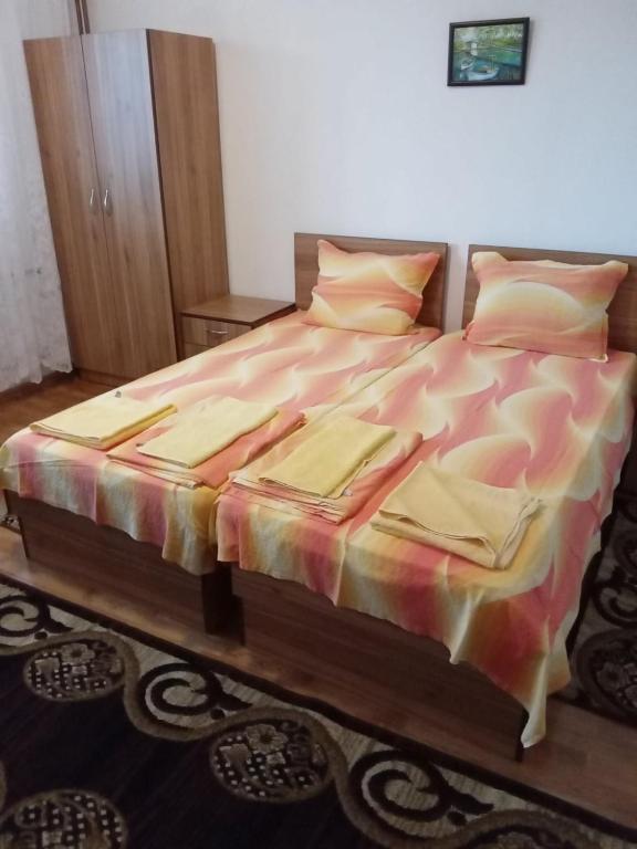 a bedroom with a bed with a colorful comforter at Стаи за гости Петрови in Primorsko