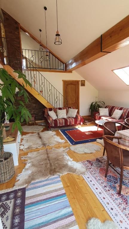 a living room with a staircase and a couch at Bran 99 in Bran