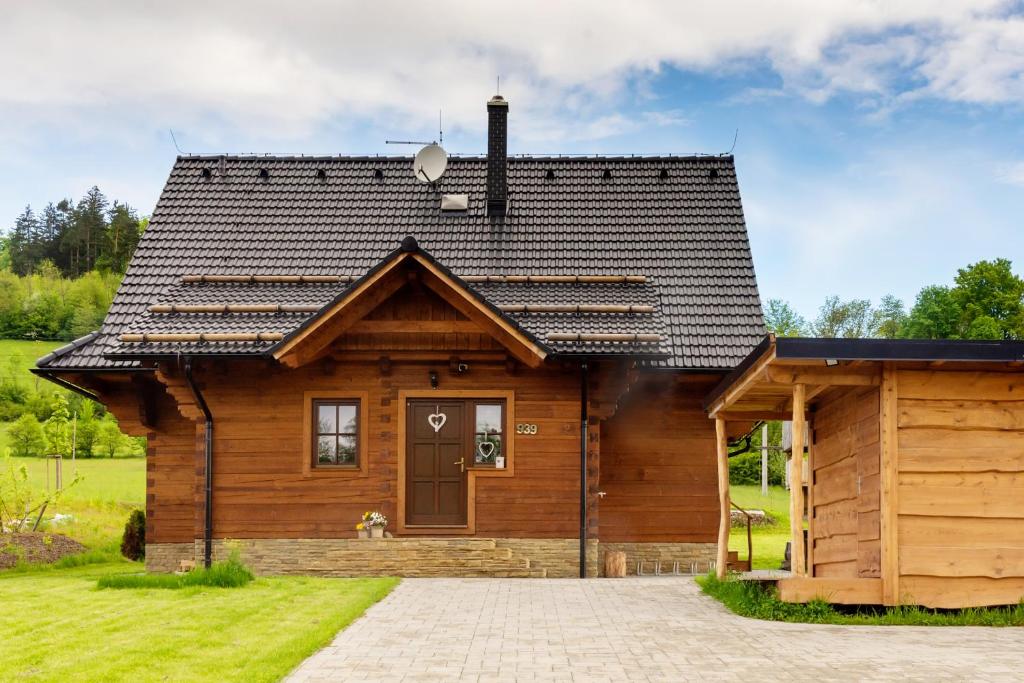 Cabaña de madera con techo negro en Chata Hrozenka WELLNESS en Nový Hrozenkov