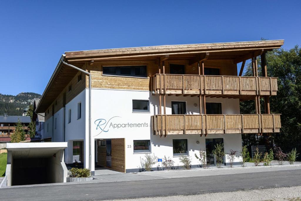 a large white building with a balcony on it at R Appartements in Tannheim
