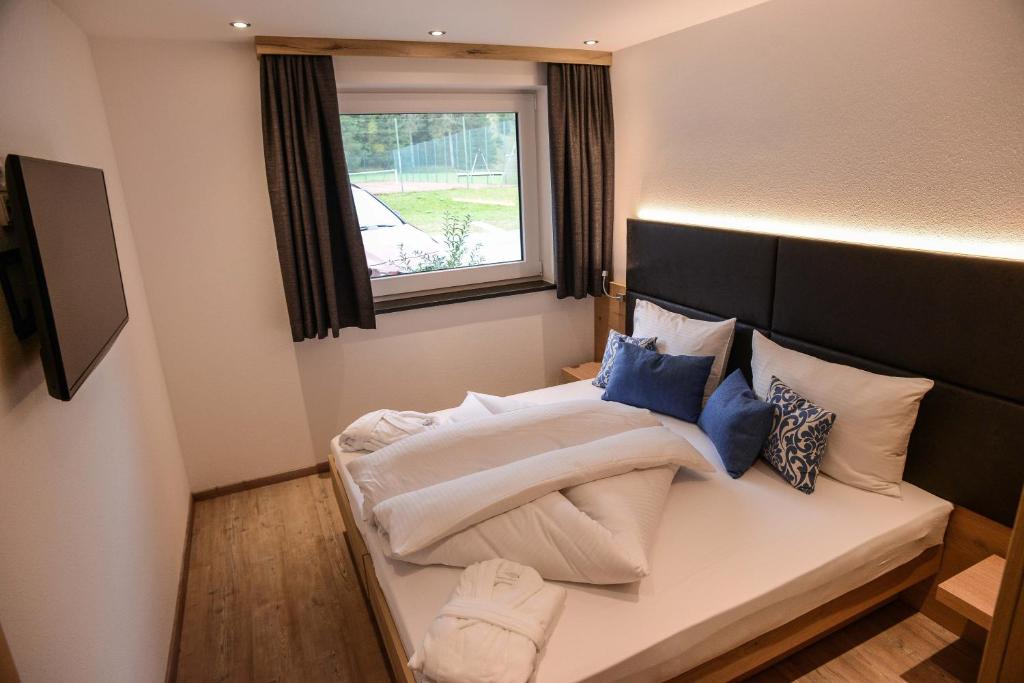 Postel nebo postele na pokoji v ubytování R Appartements Sommerbergbahnen inklusive